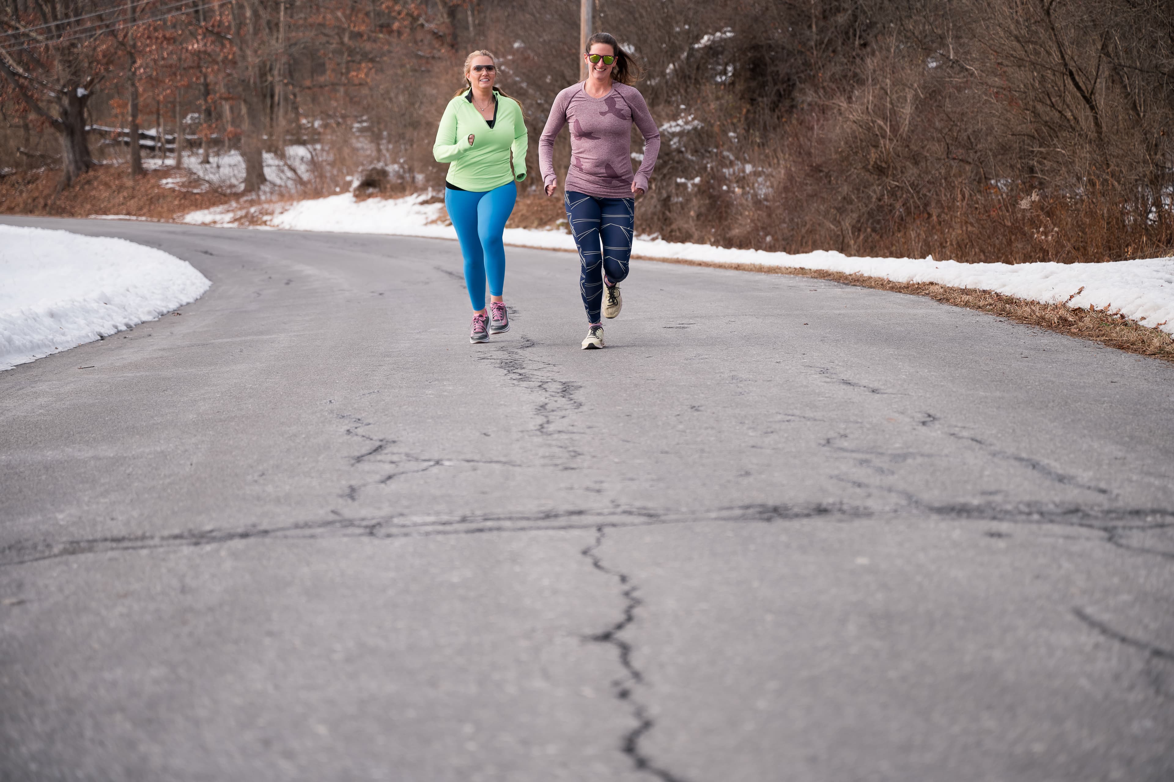 Megan James and a client running together on a snowy Capital Region road