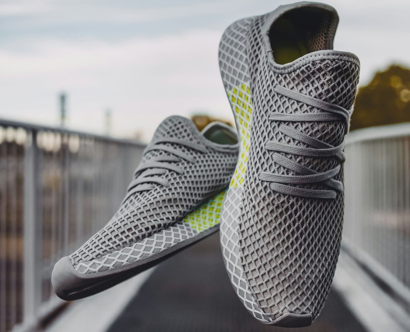 Running shoes in soft focus over a Capital Region bridge